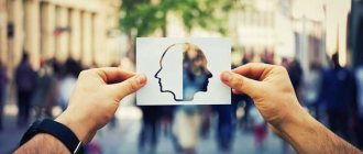 Мужчина держит в руках картинку с двумя лицами